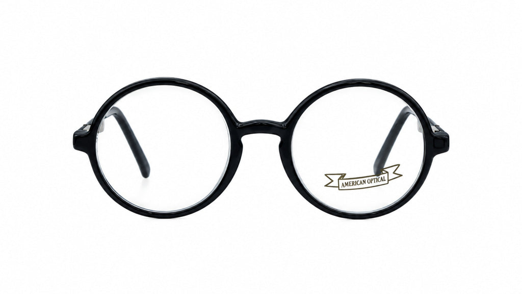 Round black eyeglass frames with clear lenses, shown from the front on a plain white background. A small 'LUMIERE OPTICS' logo is printed on the lower part of the right lens.
