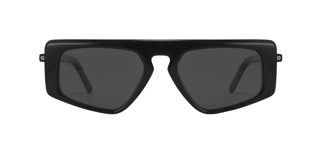 Black sunglasses with dark lenses on a light wooden surface
