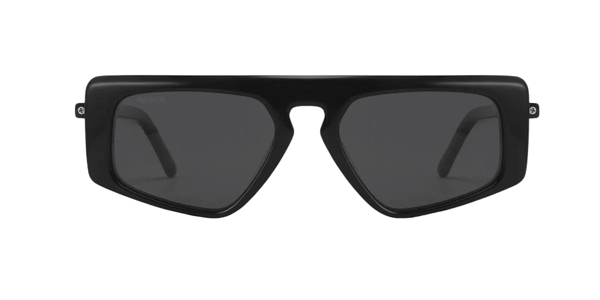 Black sunglasses with dark lenses on a light wooden surface