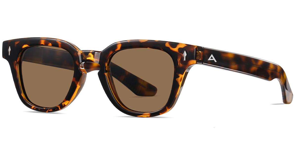 Tortoiseshell sunglasses with brown lenses, featuring a thick square frame and a small white geometric logo on the temple arm, shown against a plain white background.