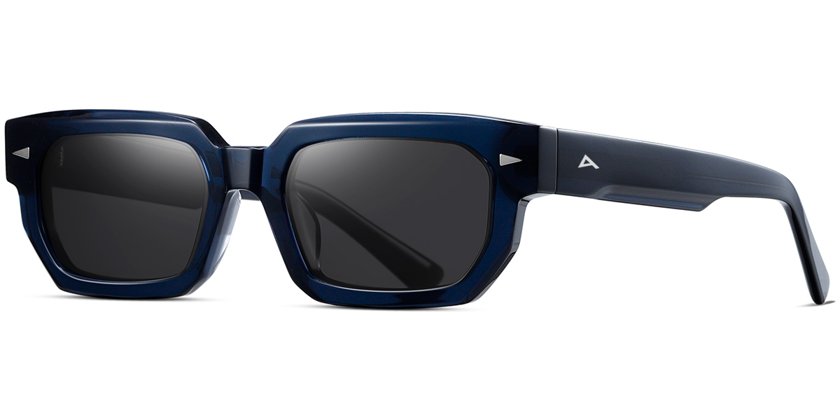 A pair of angular square sunglasses with a translucent dark blue acetate frame and dark gray lenses, shown from a three-quarters angle on a white background.