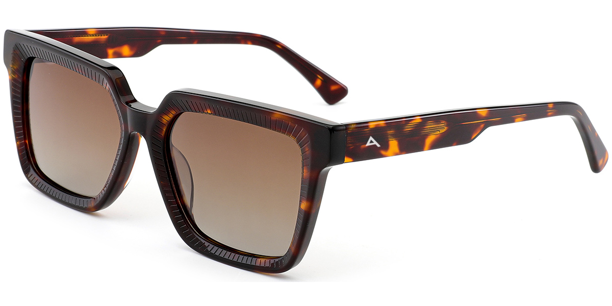A pair of designer sunglasses with a dark brown and amber tortoiseshell acetate frame and gradient brown lenses, featuring a small white geometric logo on the temple arm.