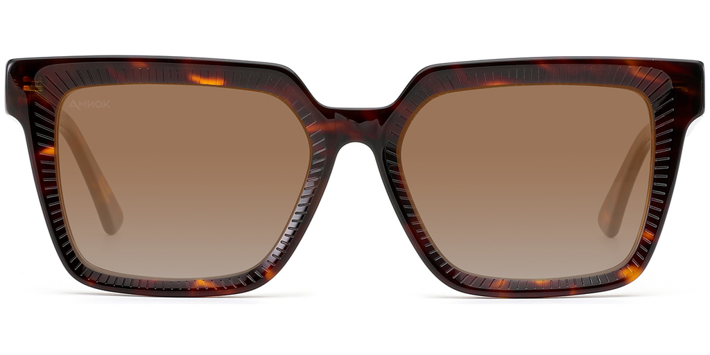 A pair of oversized square sunglasses with a dark brown and amber tortoiseshell patterned frame and brown gradient lenses, shown against a plain white background.