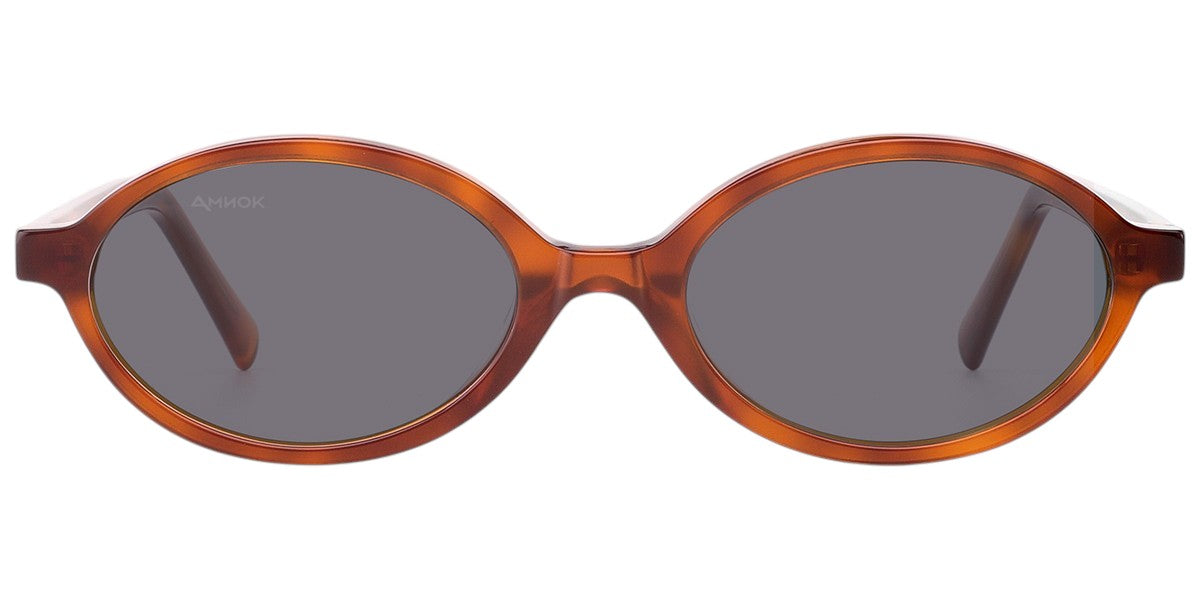 Oval sunglasses with a translucent amber-brown acetate frame and dark gray lenses, shown from the front on a white background.