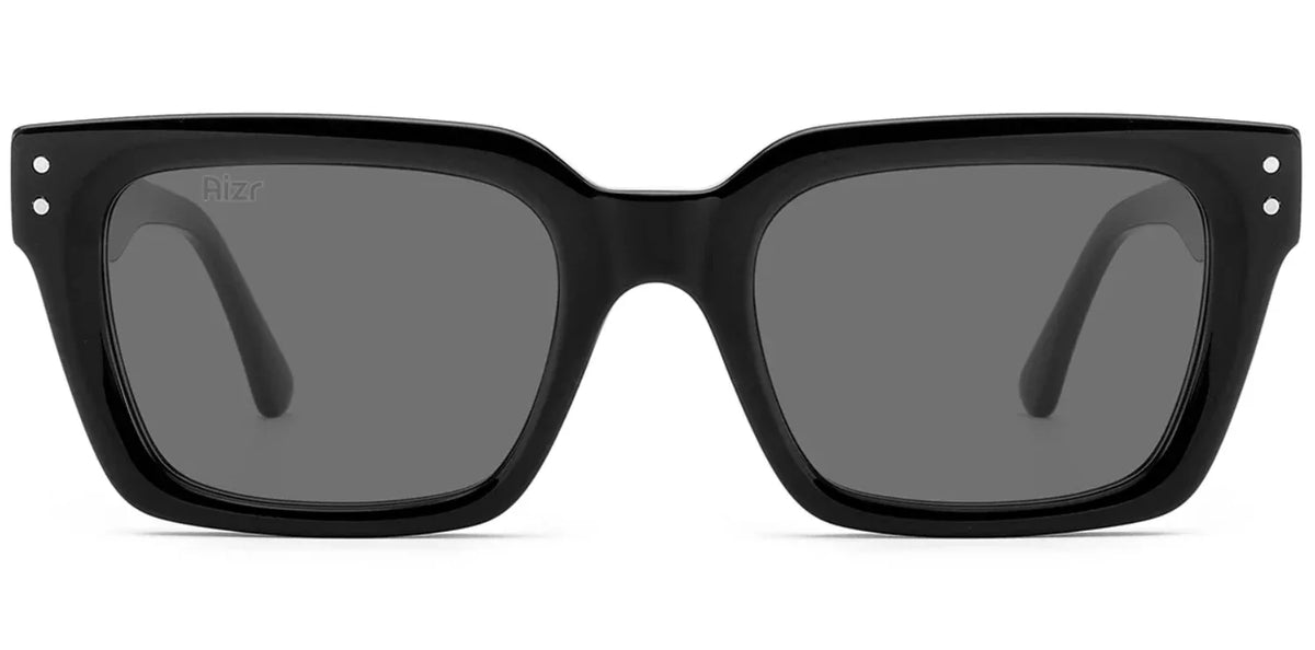 Black sunglasses with dark lenses on a white background