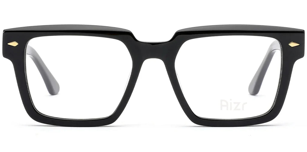 Black eyeglasses with gold accents on a white background