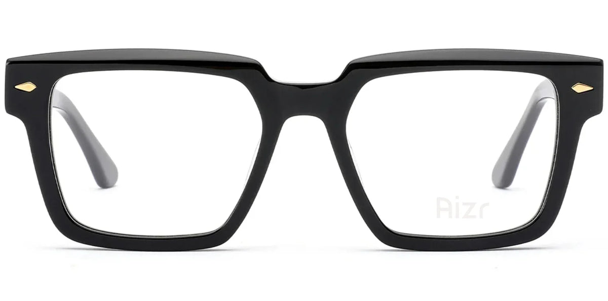 Black eyeglasses with gold accents on a white background