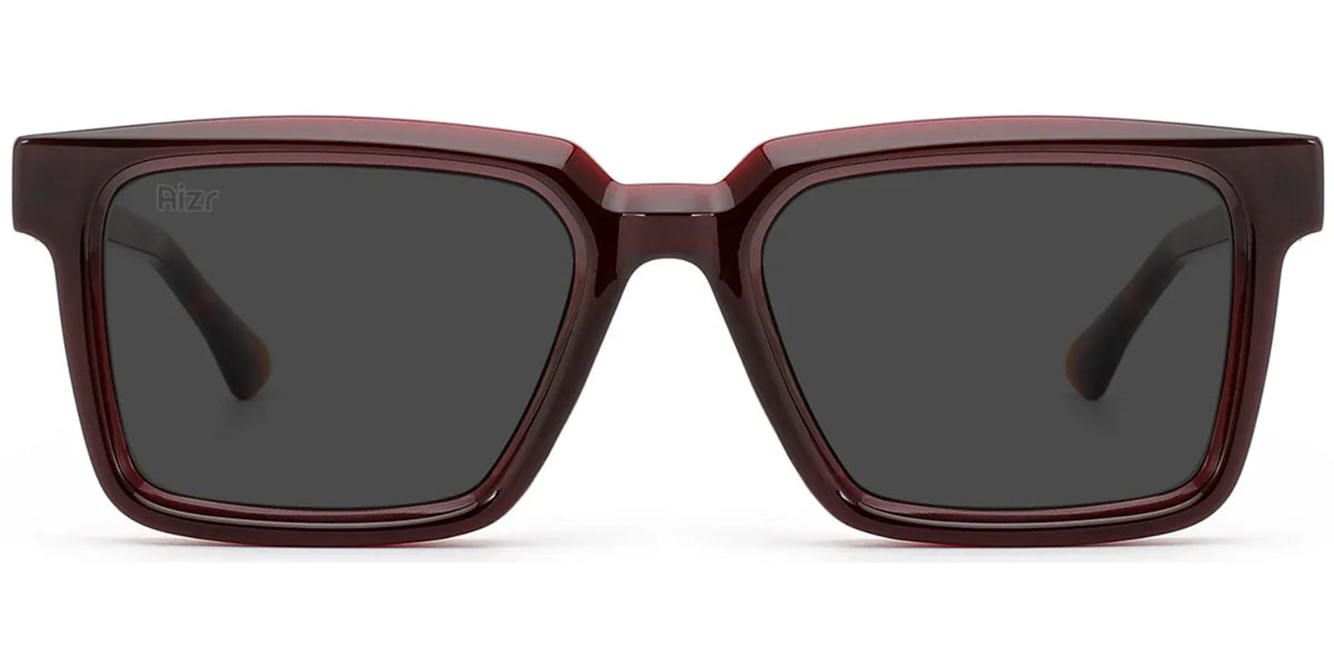 Sunglasses with a maroon frame and dark lenses on a white background