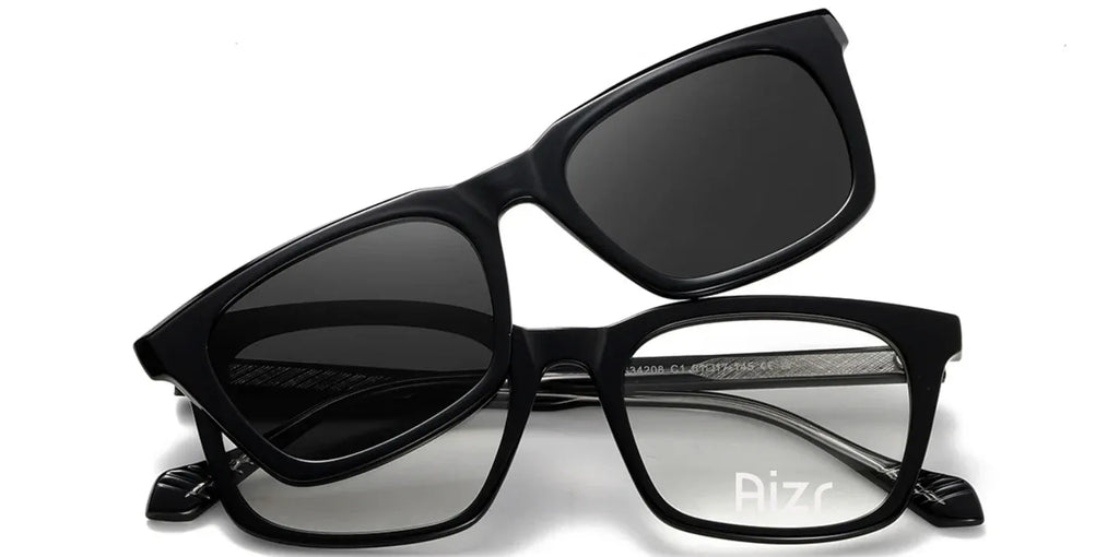 Black sunglasses with a clear lens on a white background