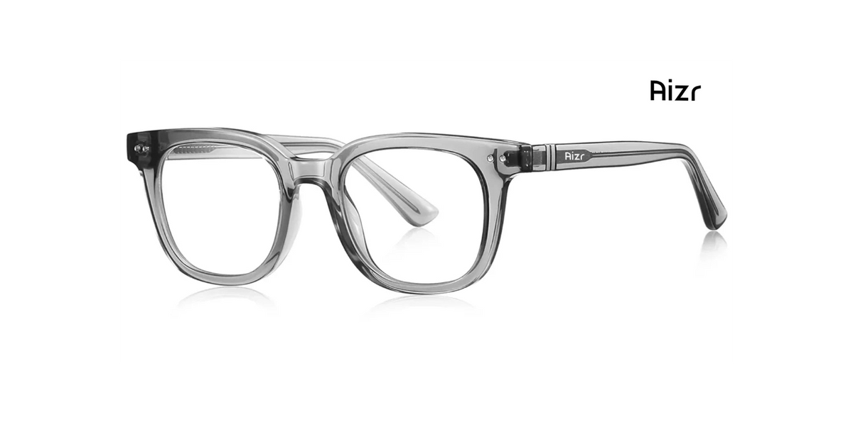 A pair of translucent gray acetate eyeglass frames with a modern square-to-rectangular shape, shown on a clean white background with a subtle reflection. The brand name 'Aizr' is printed in black on the upper right of the frame and on the temple arm.