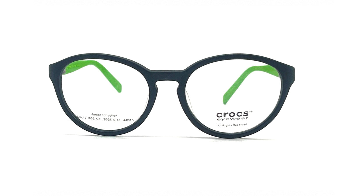 Crocs Treatment round eyeglasses in matte black with bright green inner temple accents, shown on a clean white background.