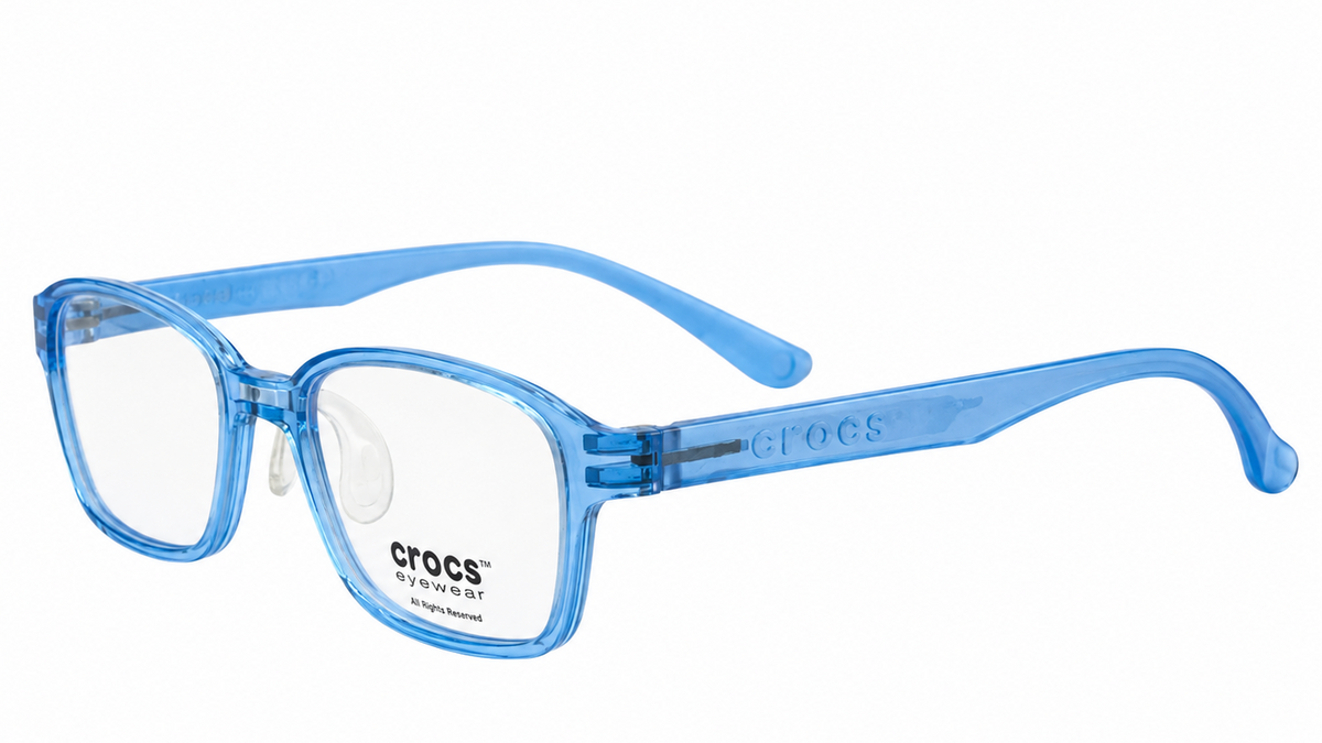 Light blue translucent Crocs eyeglasses with clear lenses, shown from a three-quarters angle on a white background.