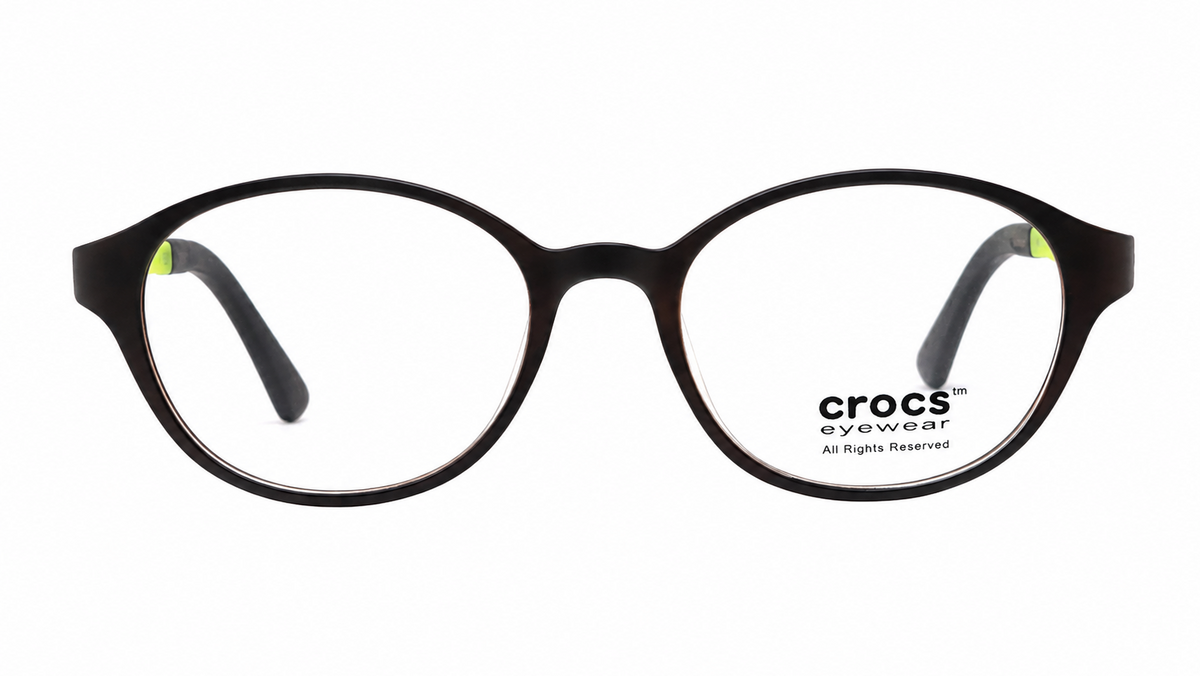 Crocs eyewear round black acetate frames with clear lenses and small lime green temple tips, shown on a white background.