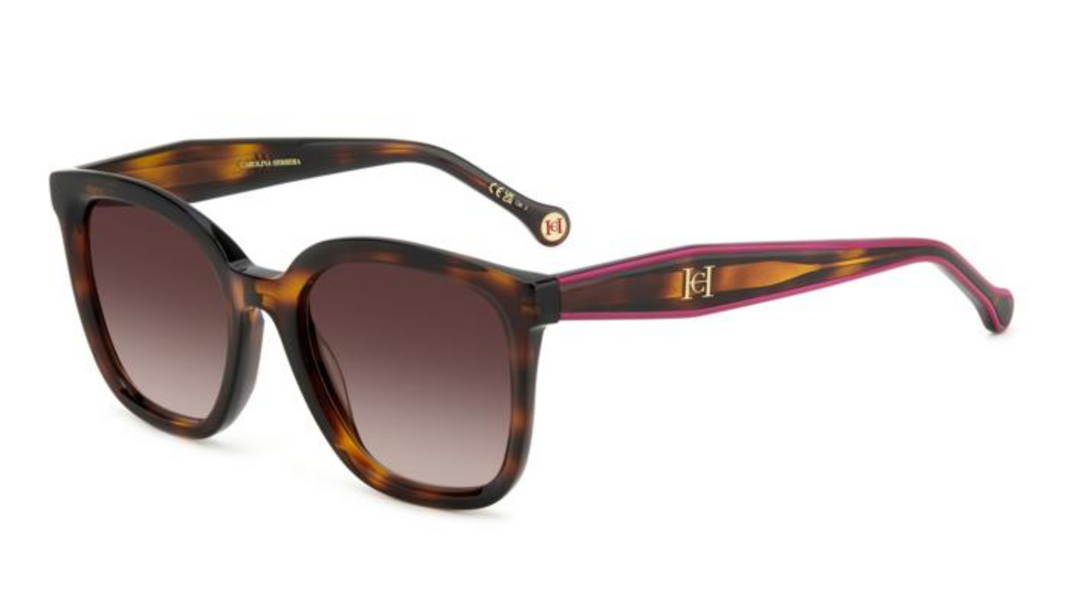 A pair of designer sunglasses with a tortoiseshell frame, brown gradient lenses, and magenta 