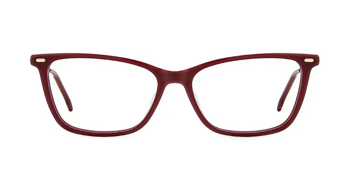 A pair of eyeglasses with a thick, rounded cat-eye frame in a translucent burgundy red acetate, featuring small gold metal accents on the hinges and clear lenses, shown against a plain white background.