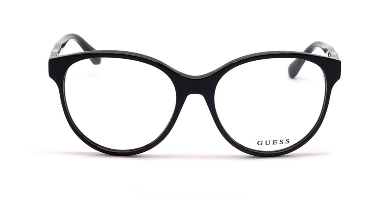 GUESS eyeglasses in black with a thick, rounded cat-eye frame and clear lenses, shown against a plain white background.