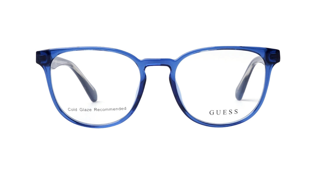 Blue translucent acetate round eyeglasses frames with clear lenses, featuring the GUESS brand name on the lower right lens.