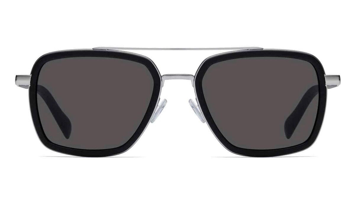 A pair of aviator-style sunglasses with a black acetate frame, dark gray lenses, and a silver metal double bridge and temples, shown against a plain white background.