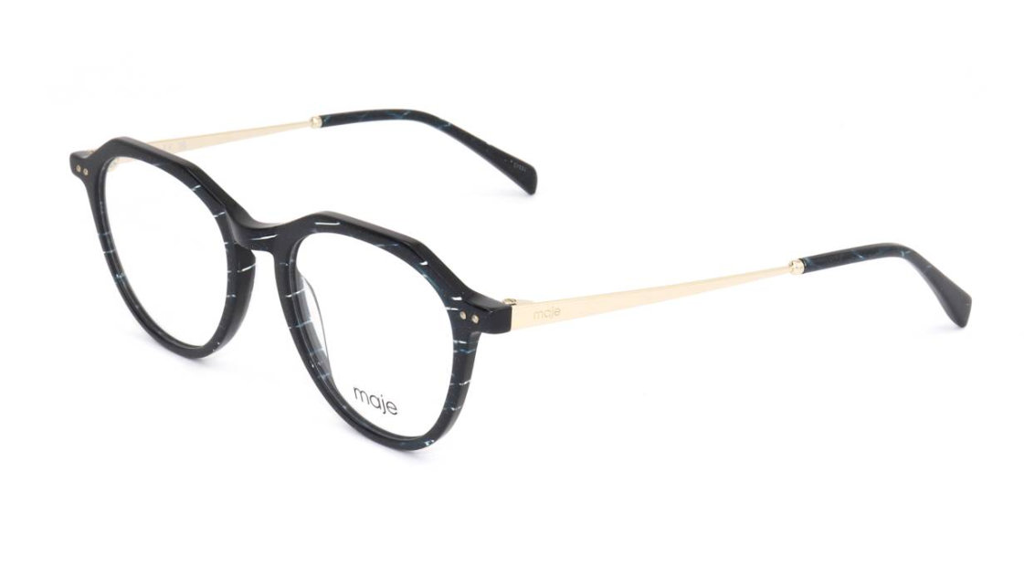 A pair of round eyeglasses with a black and white marbled acetate frame, featuring gold metal temples and clear lenses. The brand name 'maie' is printed on the lower left rim.