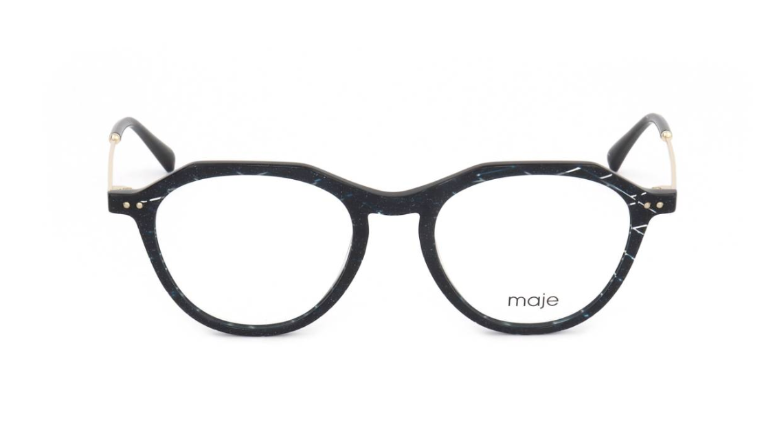 A pair of round eyeglasses with a black and white marbled acetate frame, gold metal hinge accents, and clear lenses. The brand name 'maje' is printed in black on the lower right lens.
