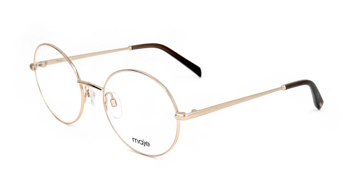 Oval metal eyeglasses with thin gold-toned frames, clear lenses, and dark brown acetate temple tips. The brand name 'maje' is printed on the lower left lens.