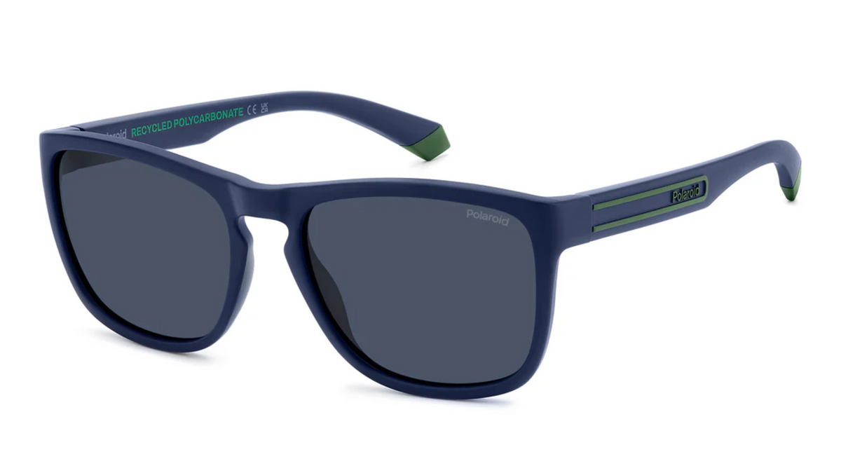 A pair of sunglasses with a navy blue frame, dark gray lenses, and green accents on the temples, shown on a plain white background.