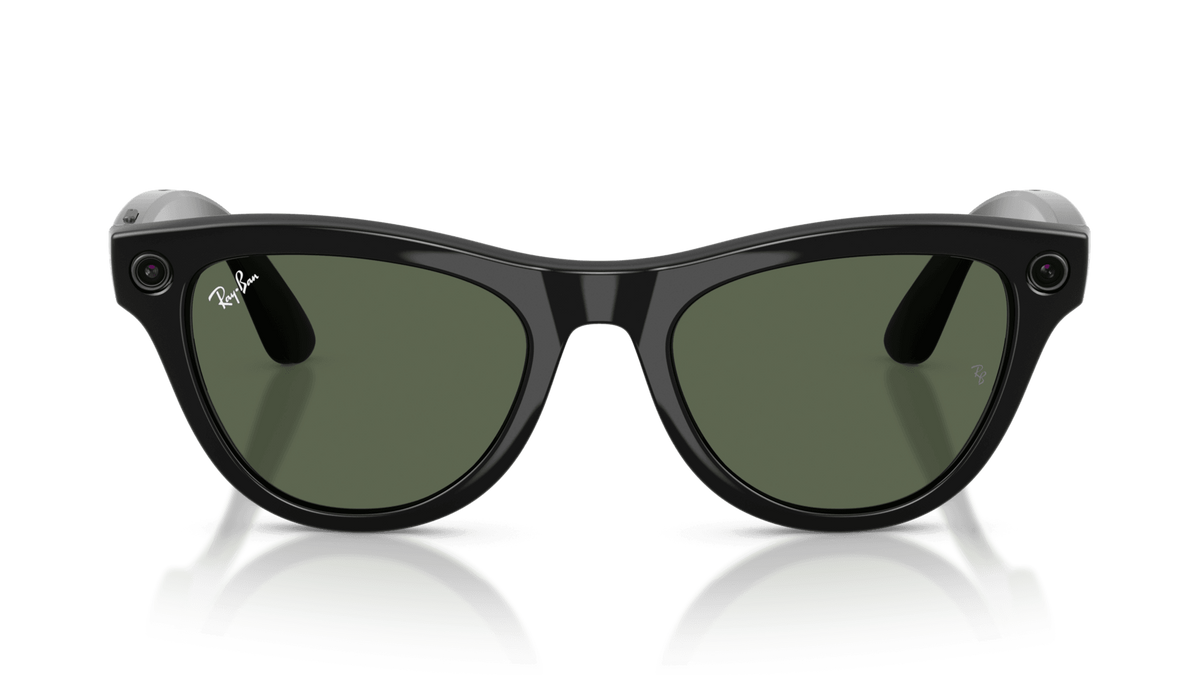 Ray-Ban | Meta Skyler Shiny Black - Gen 2  Black sunglasses with green lenses on a reflective surface against a blue gradient background