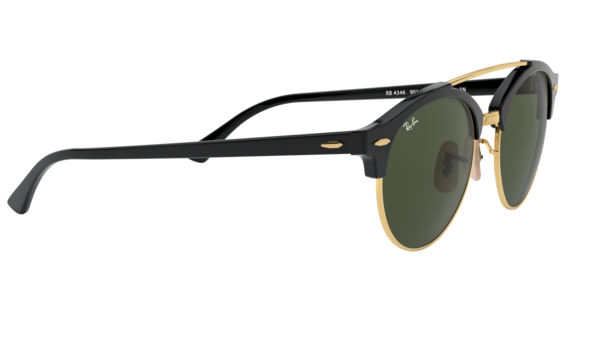 Ray-Ban sunglasses featuring a black acetate frame with gold trim, dark green lenses, and gold metal hinges, shown on a plain white background.