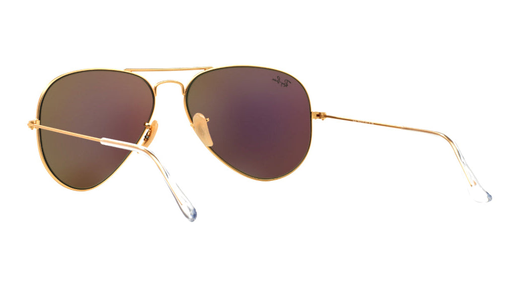 A pair of classic aviator sunglasses with gold metal frames and brown-tinted lenses, shown from a three-quarters angle on a light gray background.