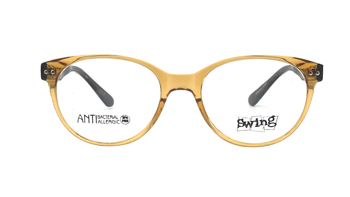 A pair of cat-eye eyeglasses with a translucent amber-yellow acetate frame, clear lenses, and dark gray temple tips. The brand name 'swing' is printed on the right lens, and 'ANTI BACTERIAL TINTED' is printed on the left.