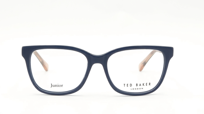A pair of Ted Baker Junior eyeglasses in navy blue acetate with clear lenses and light beige temple tips, shown against a plain white background.