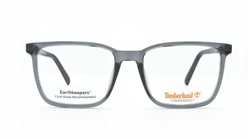 A pair of Timberland Earthkeepers eyeglasses with a translucent dark gray acetate frame and clear cold-rolled lenses, shown against a plain white background.