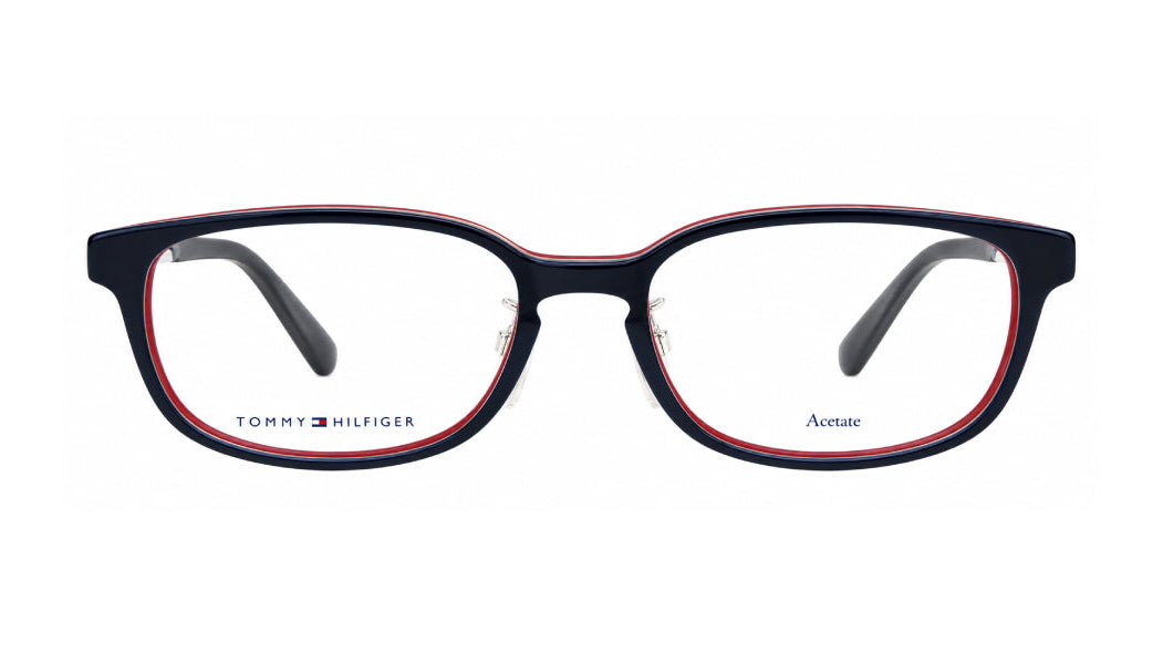 Tommy Hilfiger acetate eyeglasses with a navy blue front, red inner border, and clear lenses, shown against a plain white background.