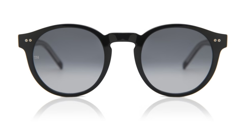 Round black sunglasses with dark gray gradient lenses, shown from the front on a white background with a soft reflection below.