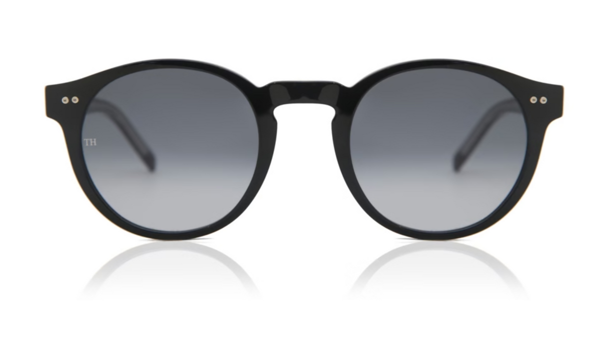 Round black sunglasses with dark gray gradient lenses, shown from the front on a white background with a soft reflection below.